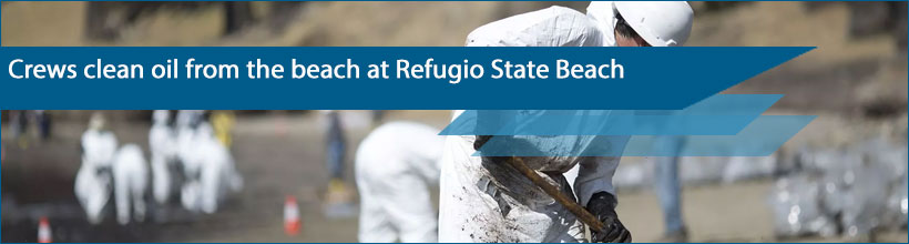 Crews clean oil from the beach at Refugio State Beach north of Goleta, Calif